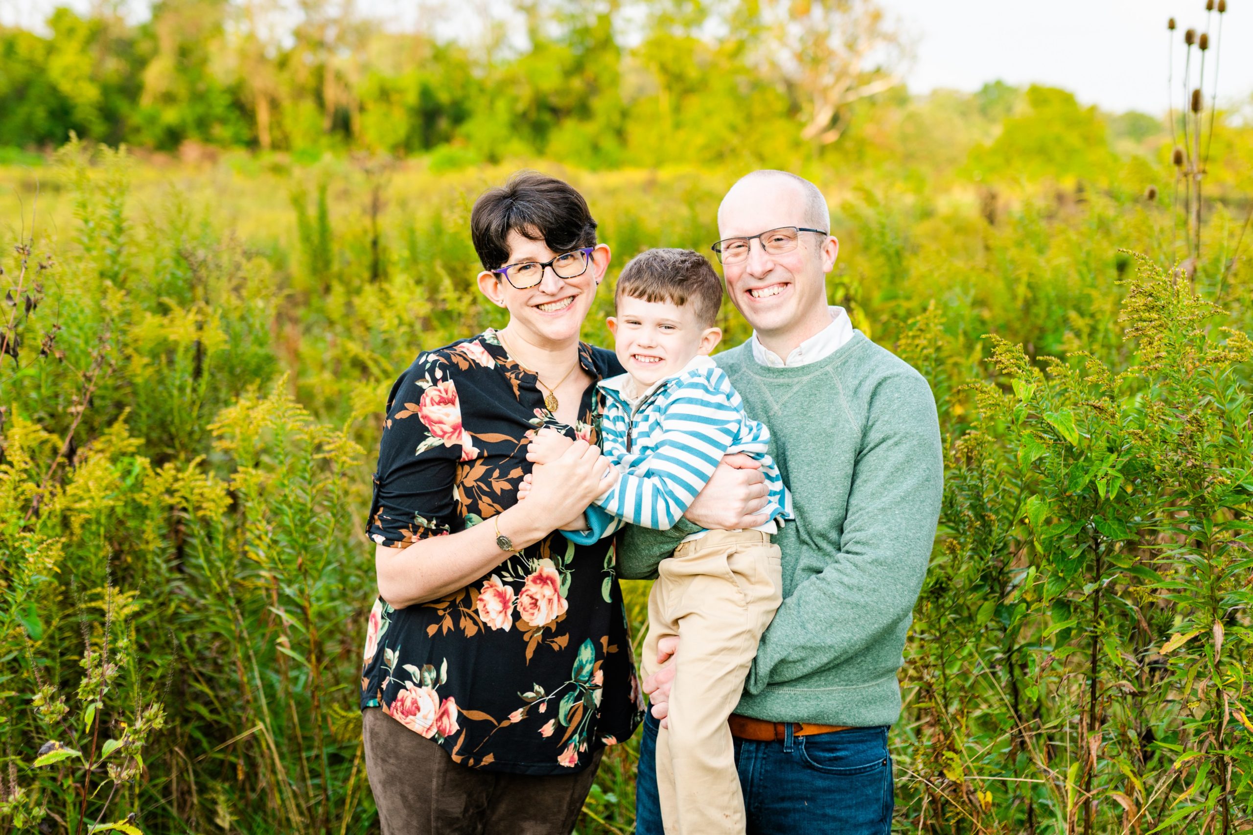 portrait of a family of 3 in a field at Glenwood Gardens