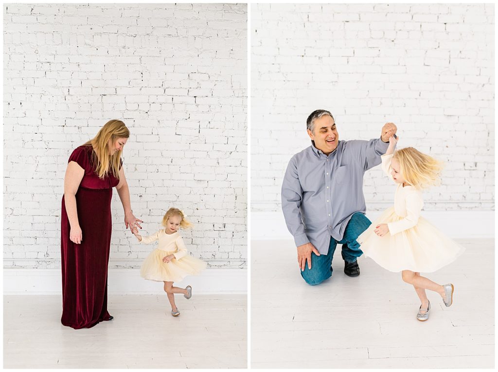 girl twirling in her dress with mom and dad